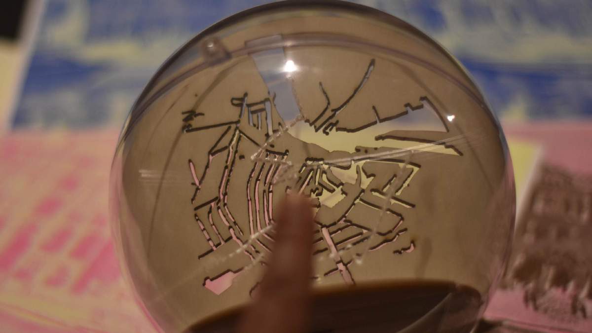 Components — dome halves and laser-cut map discs on dark background